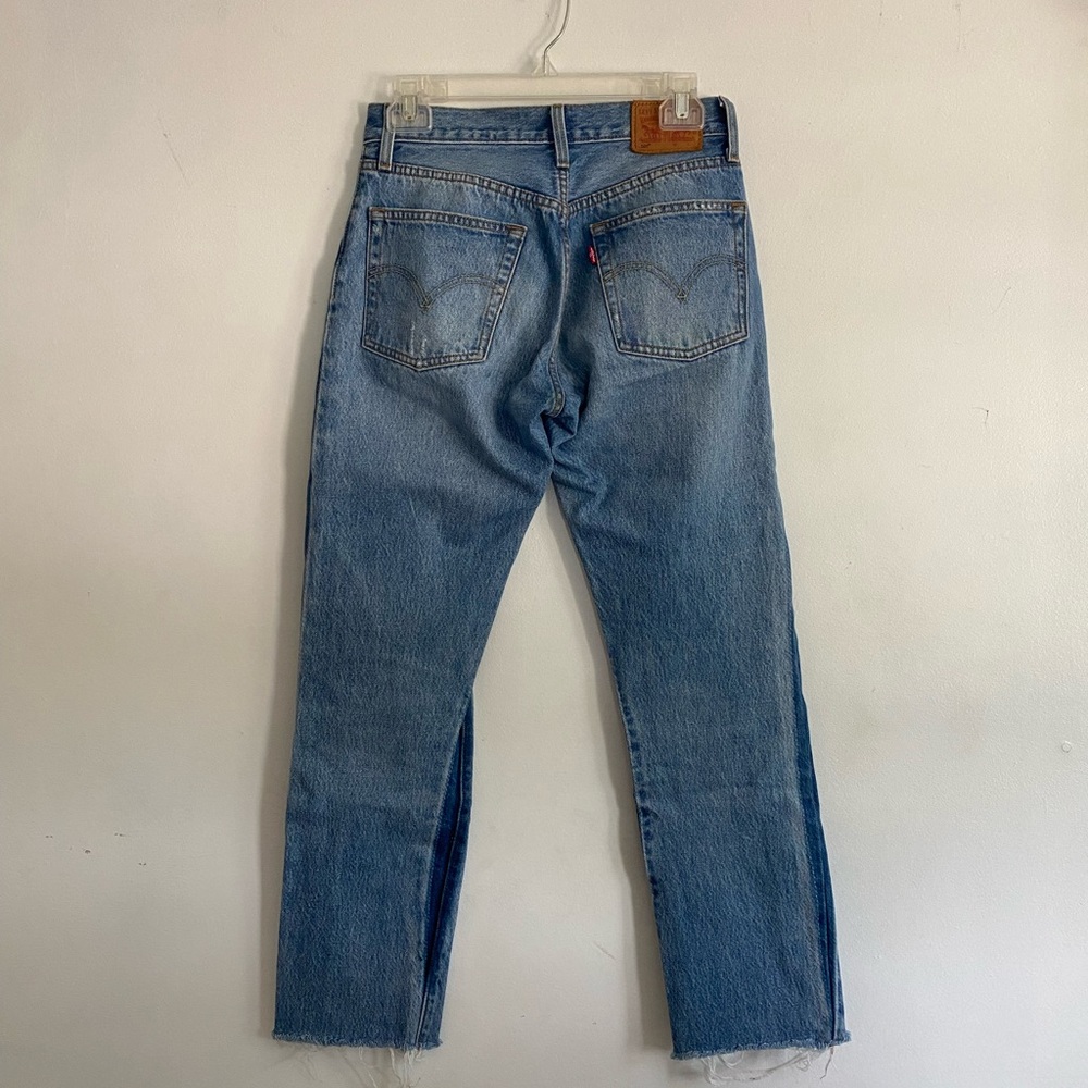 Levi’s jeans, size 0, distressed, dark wash on sides